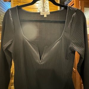 Long sleeved, black V-cut bodysuit